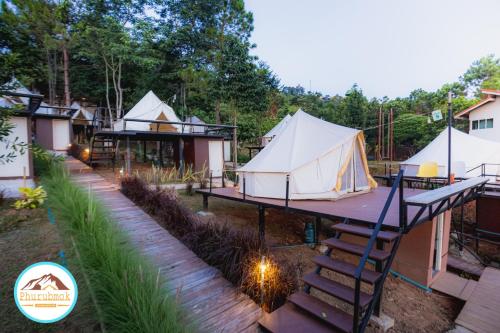a group of tents in a yard with a ladder at Phurubmok khaokho in Khao Kho
