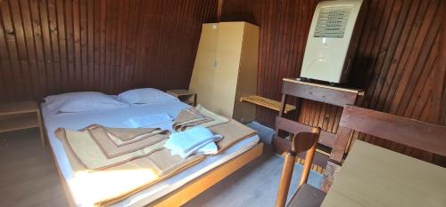 a bedroom with a bed with towels on it at FKK Ada Bojana in Ulcinj