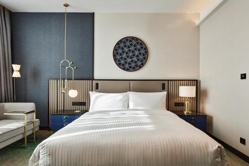a bedroom with a large bed and a couch at InterContinental Tashkent by IHG in Tashkent