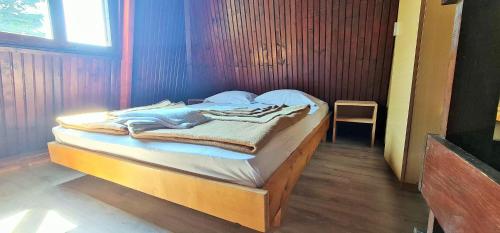 a small bed in a room with a chair at FKK Ada Bojana in Ulcinj