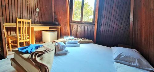 a bedroom with a bed with towels on it at FKK Ada Bojana in Ulcinj