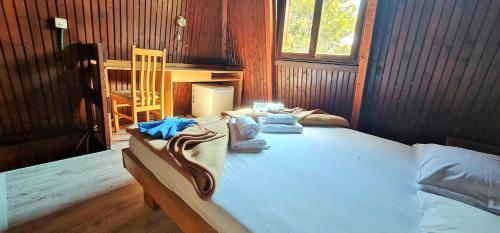 a bedroom with a bed with towels on it at FKK Ada Bojana in Ulcinj