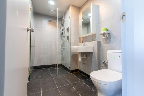 a bathroom with a toilet and a sink and a shower at Margo Home - Jesselton Quay in Kota Kinabalu