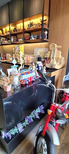 a room with a desk with a toy motorcycle on it at TK Happiness 168 B&B in Donggang