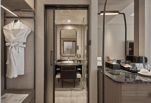 a bathroom with a sink and a mirror at La Siesta Premium Saigon in Ho Chi Minh City