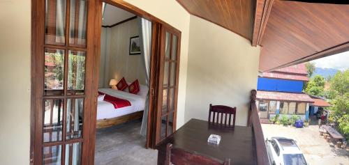 a room with a bedroom with a bed and a balcony at Le KhounSok Boutique Hotel in Luang Prabang