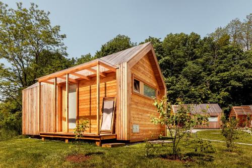 a wooden cabin in a field with trees at Glamping Mountain Fairy Tale in Bistrica pri Tržiču