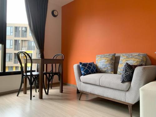 a living room with a couch and a table at The Base Central Phuket in Phuket