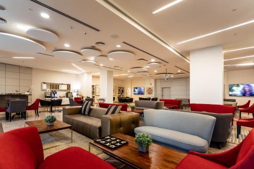 a waiting room with couches and chairs at Benjamin Business Hotel in Herzelia 