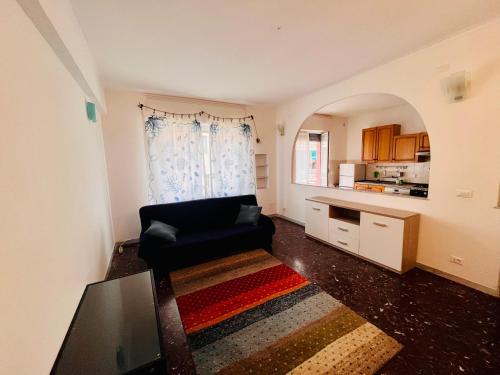 ein Wohnzimmer mit einem Sofa und einer Küche in der Unterkunft Casa Mirosa in Arenzano