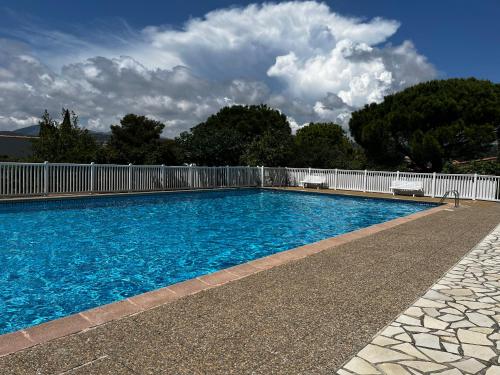 une piscine avec une clôture blanche et de l'eau bleue dans l'établissement La petite bohême K6conciergerie, à Cassis