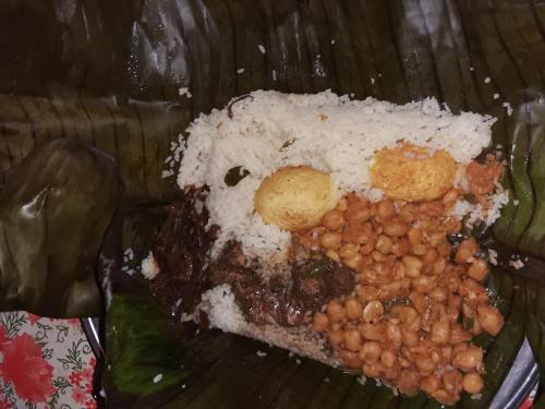 a plate of food with rice and beans at OM Homestay in Bentota