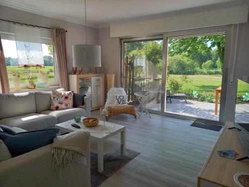 a living room with a couch and a table at Ferienhaus Dat Landhuus 95158 in Rhauderfehn