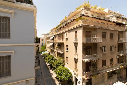 an apartment building with plants on the balconies at Minimal apartment in Plaka in Athens