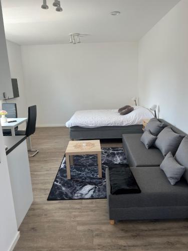 a living room with a couch and a bed at Solberga lägenhetshotell in Köpingsvik