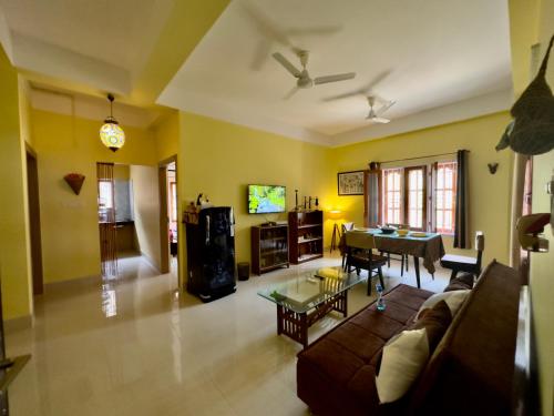 a living room with a couch and a table at Three Little Birds Homestay in Guwahati