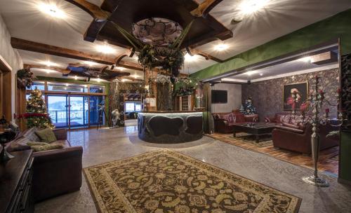 a large living room with couches and a rug at Hotel Galileo Donovaly in Donovaly