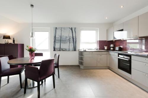 a kitchen and dining room with a table and chairs at VILLA MON BIJOU _ OG_Fewo in Göhren-Lebbin