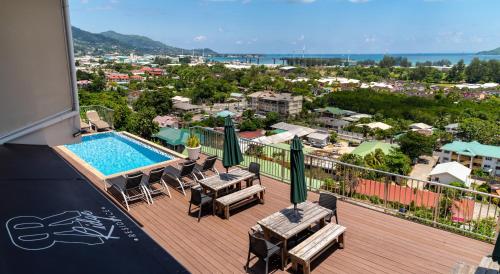 a balcony with a swimming pool and patio furniture at The Ridge Residence in Victoria