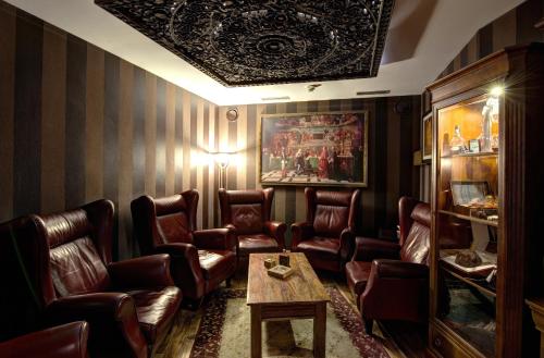 a waiting room with leather chairs and a table at Hotel Galileo Donovaly in Donovaly