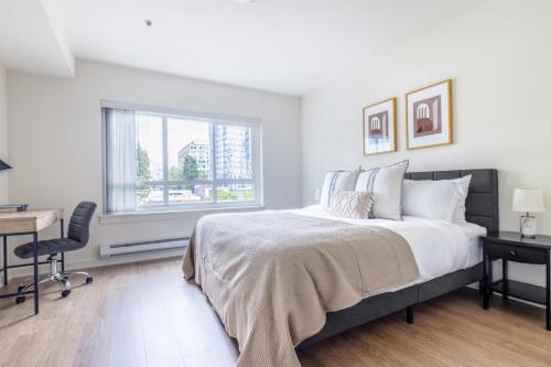a bedroom with a bed and a desk and a window at Downtown Bellevue 2BR w WD Rooftop nr all SEA-141 in Bellevue