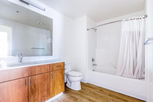 a bathroom with a sink and a toilet and a tub at Downtown Bellevue 2BR w WD Rooftop nr all SEA-141 in Bellevue