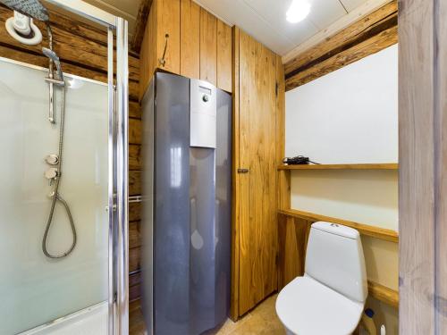 a small bathroom with a refrigerator and a toilet at Pädaste Välja Apartments in Pädaste