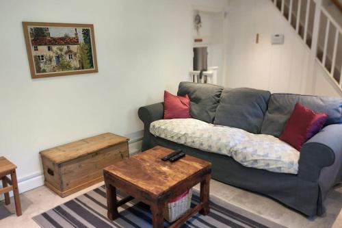 a living room with a couch and a table at Ashdown Forest character cottage, 18th Century in Crowborough