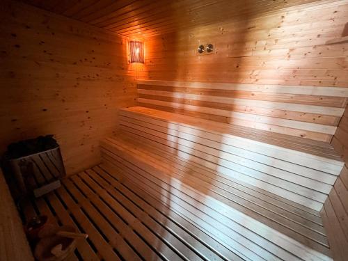 a wooden sauna with a bench in the middle at KK Apartment Bajša 