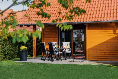 a patio with chairs and a table in front of a house at Ferienhaus Hödur in Hasselfelde