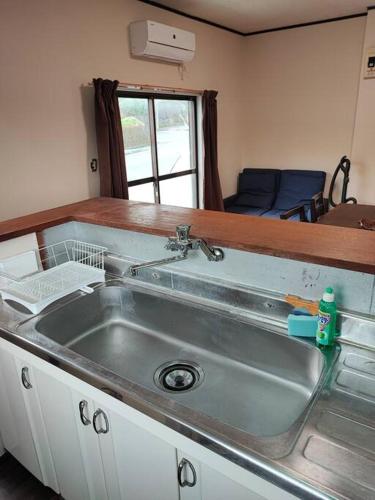 a kitchen with a sink and a counter top at Cliff top Terrace in Kuranomoto