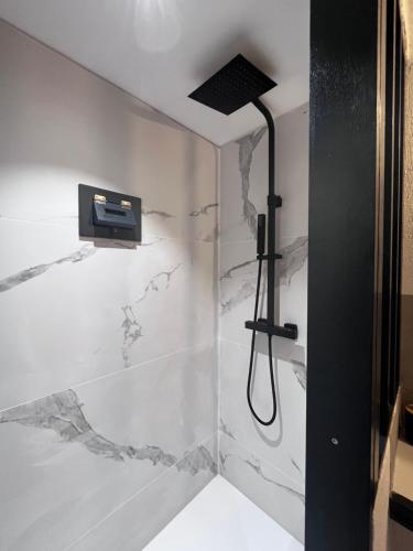 a bathroom with a shower with white marble at Torra di Ciocce in Pino
