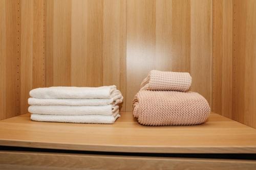 two stacks of towels on a shelf in a room at Стильные апартаменты Dotan in Netanya
