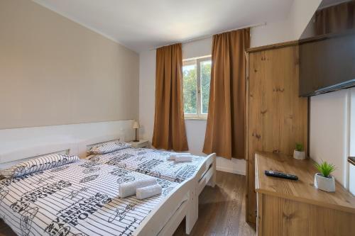 a bedroom with a large bed and a television at Villa Medulin in Medulin
