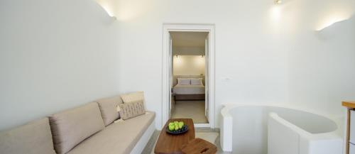 a living room with a couch and a table at Aethria Villa in Imerovigli