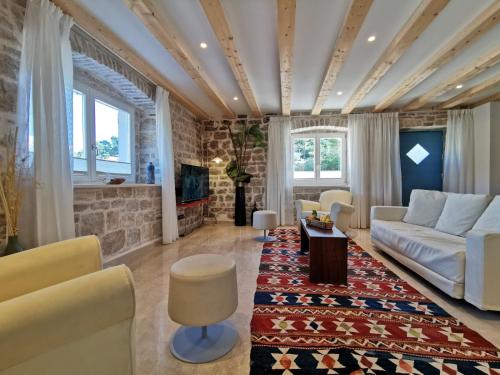 a living room with a couch and a table at Diocletian Solta in Rogač