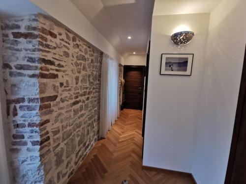 a hallway with a stone wall and a brick wall at Diocletian Solta in Rogač