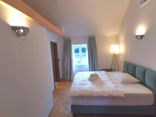 a bedroom with a bed and a lamp in it at Diocletian Solta in Rogač