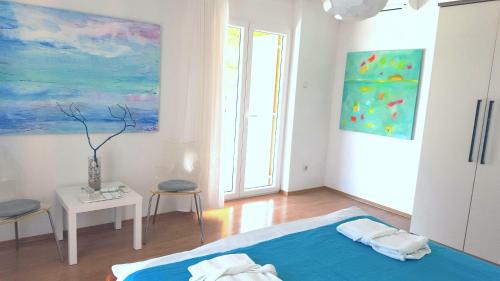 a bedroom with a bed and a painting on the wall at Rooms Kata in Rovinj