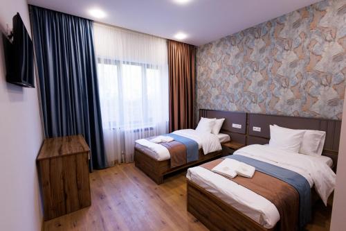 a hotel room with two beds and a window at Dream Hotel in Haghpat