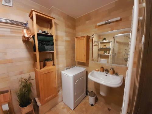 a bathroom with a toilet and a sink at Reload Apartment in Miskolc