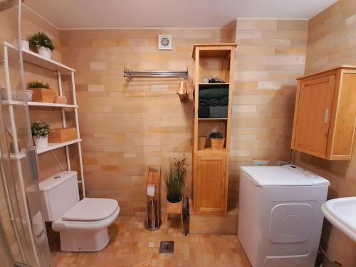 a bathroom with a toilet and a sink at Reload Apartment in Miskolc