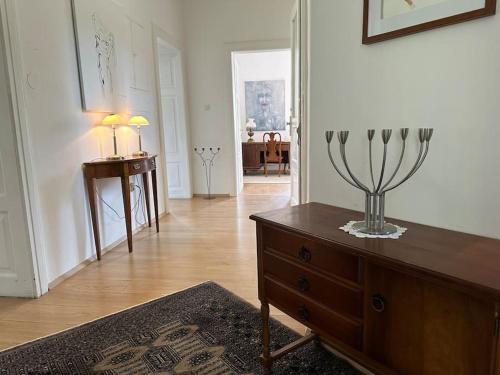a living room with a dresser with a vase on it at The Classy Sassy in Ljubljana