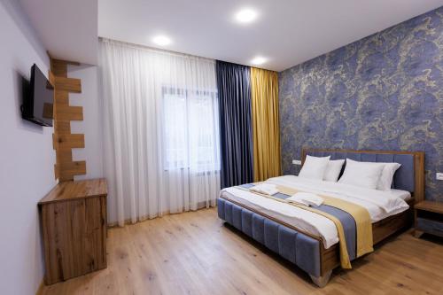 a bedroom with a large bed and a window at Dream Hotel in Haghpat