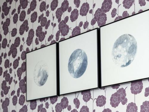 a wall with four pictures of the moon at Panorama Niseko in Kutchan