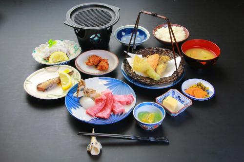 a group of plates of food on a table at Family Ryokan Kawakyu with Showa Retro, private hot spring in Ibusuki