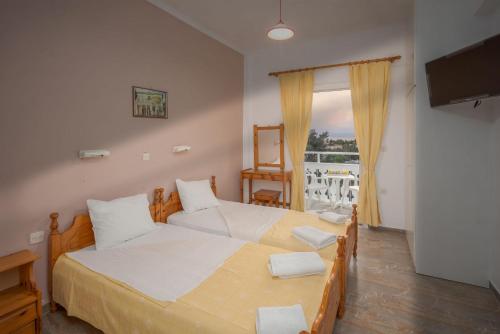 a bedroom with two beds and a balcony at Corfu Panorama by Estia in Moraitika