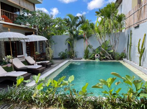 a swimming pool in the backyard of a house at Balcony Living Apartment in Seminyak