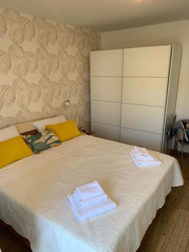 a bedroom with a bed with towels on it at Sun&Fun Studio Apartment in Hvar
