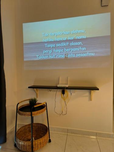 a sign on the wall of a room with a table and a chair at New The Sun Homestay at Sg Nibong nearby Queensbay or PISA or FTZ Bayan Lepas HENG in Bayan Lepas